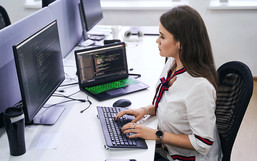 A woman staring at monitor