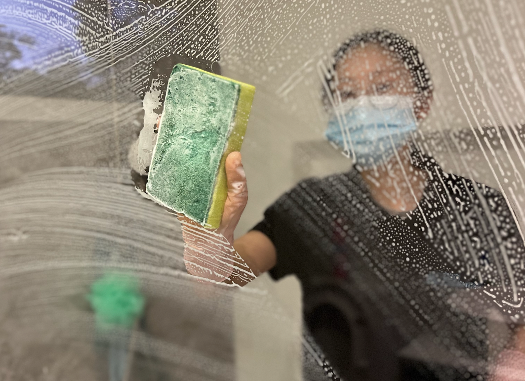 A woman cleaning glass door