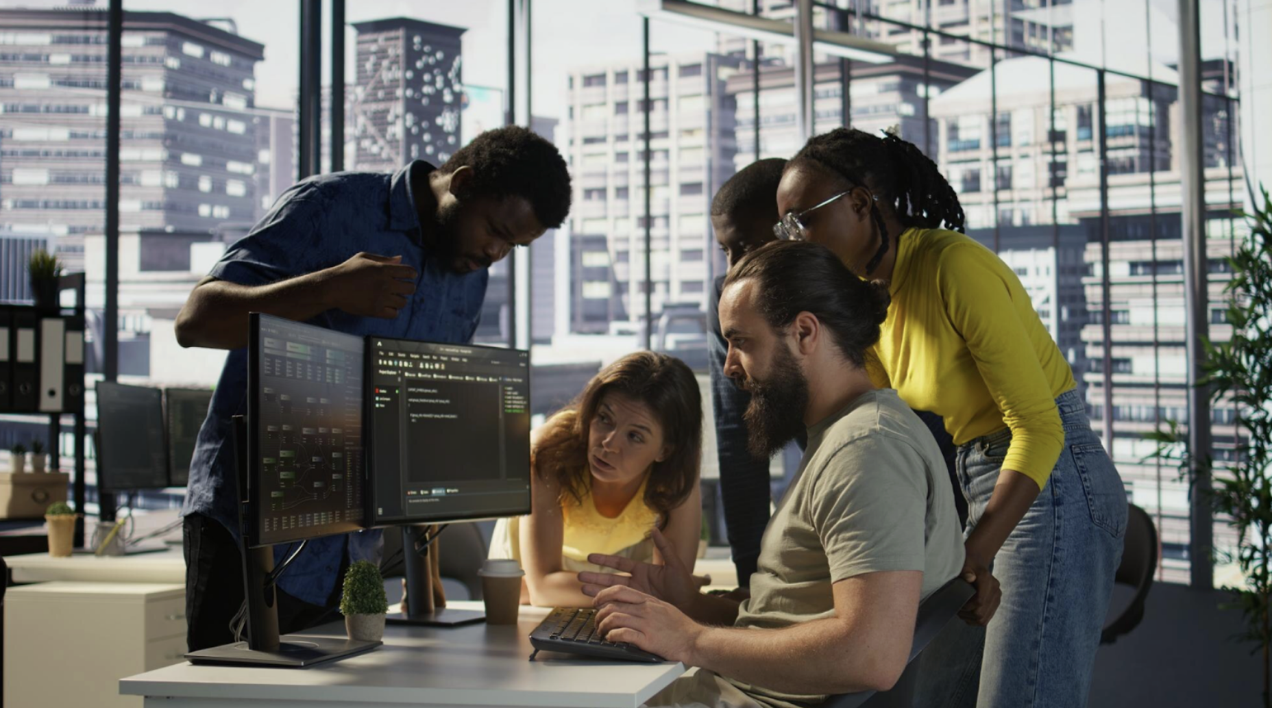 Team gathered around a computer screen