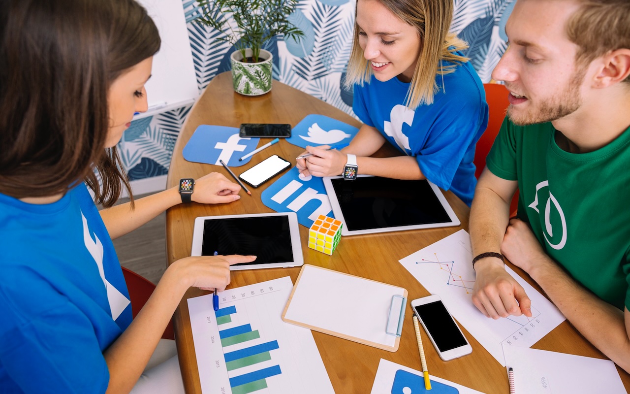 A group of people looking at different analytical graphs and charts at the desk