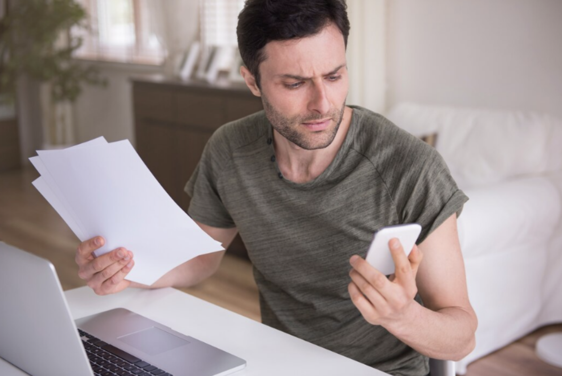 Man looking at bills