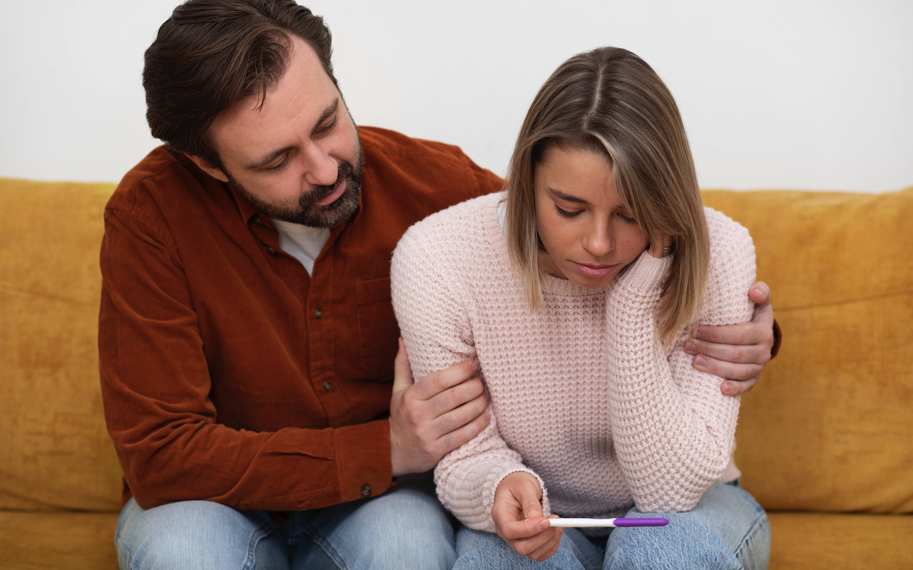 Couple holding pregnancy test