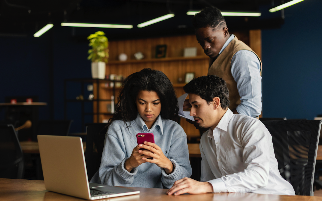 Team looking at cell phone