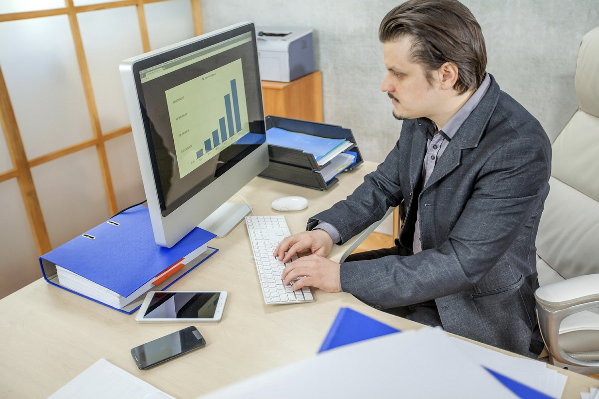 Business professional analyzing maintenance data on computer in office