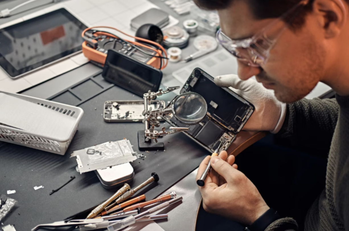Smartphone repair technician working on device components
