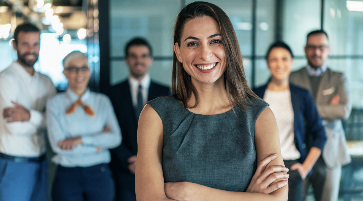 Business leader standing with a professional remote team