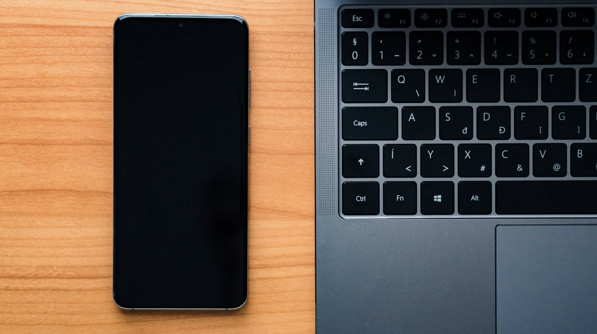 Android smartphone beside a laptop