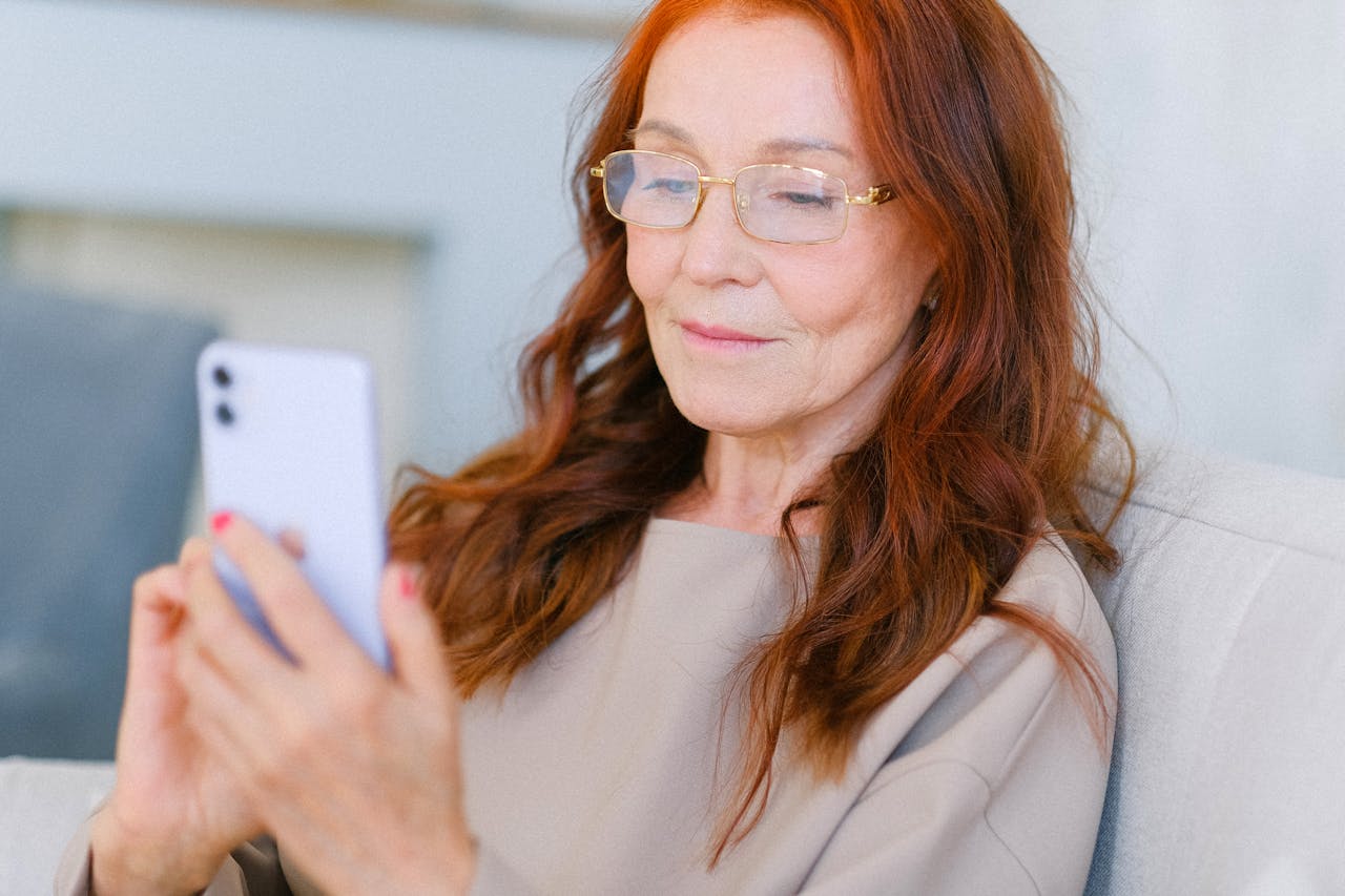 Elderly woman with red hair making a video call