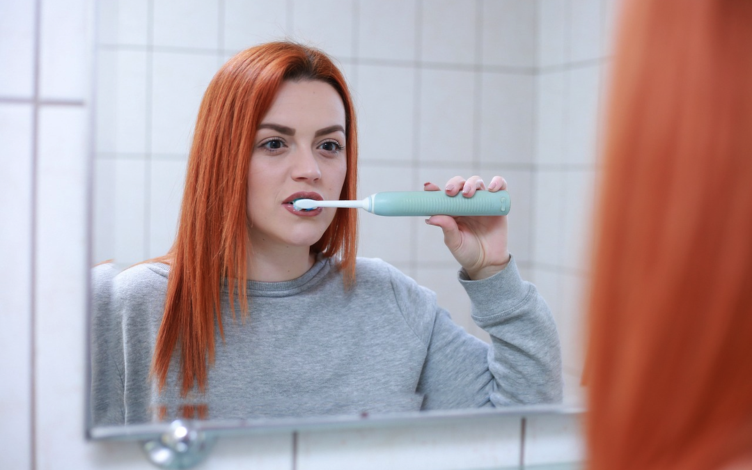 A woman brushing teeth