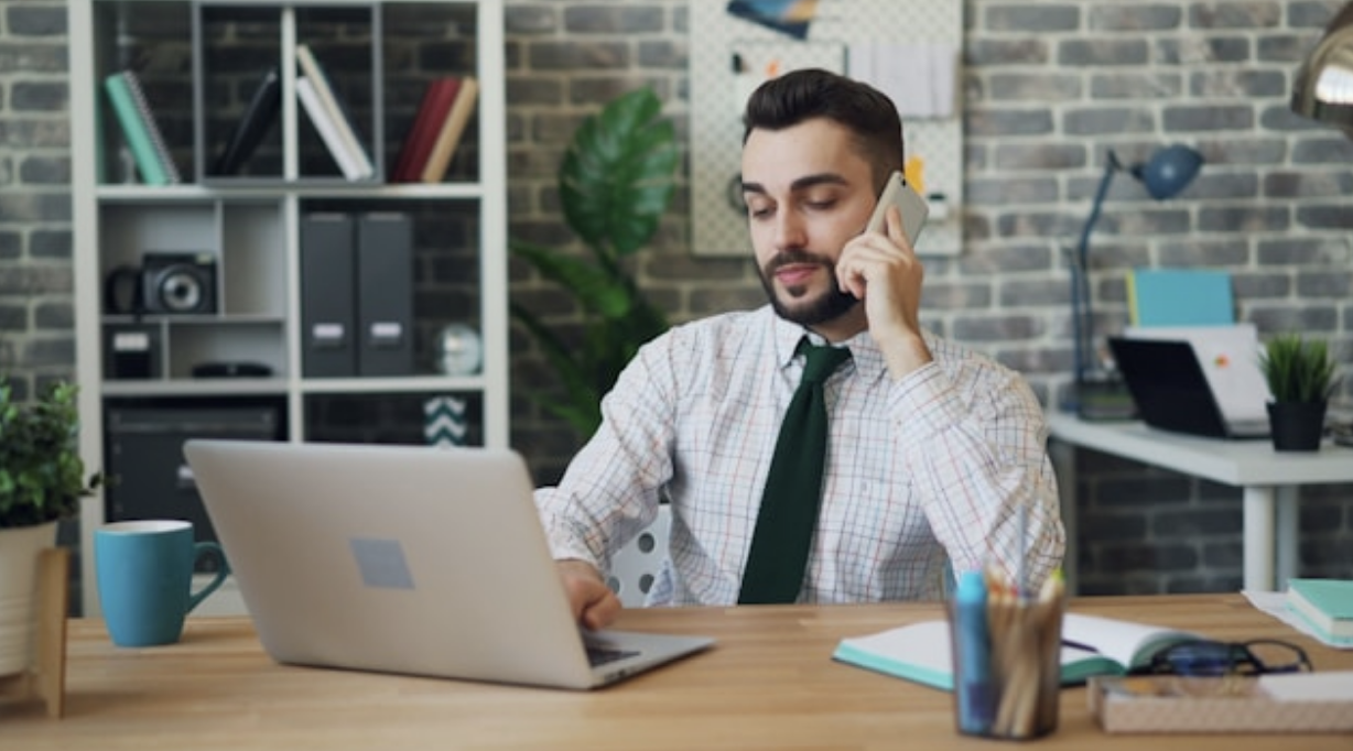 Man on call using a laptop