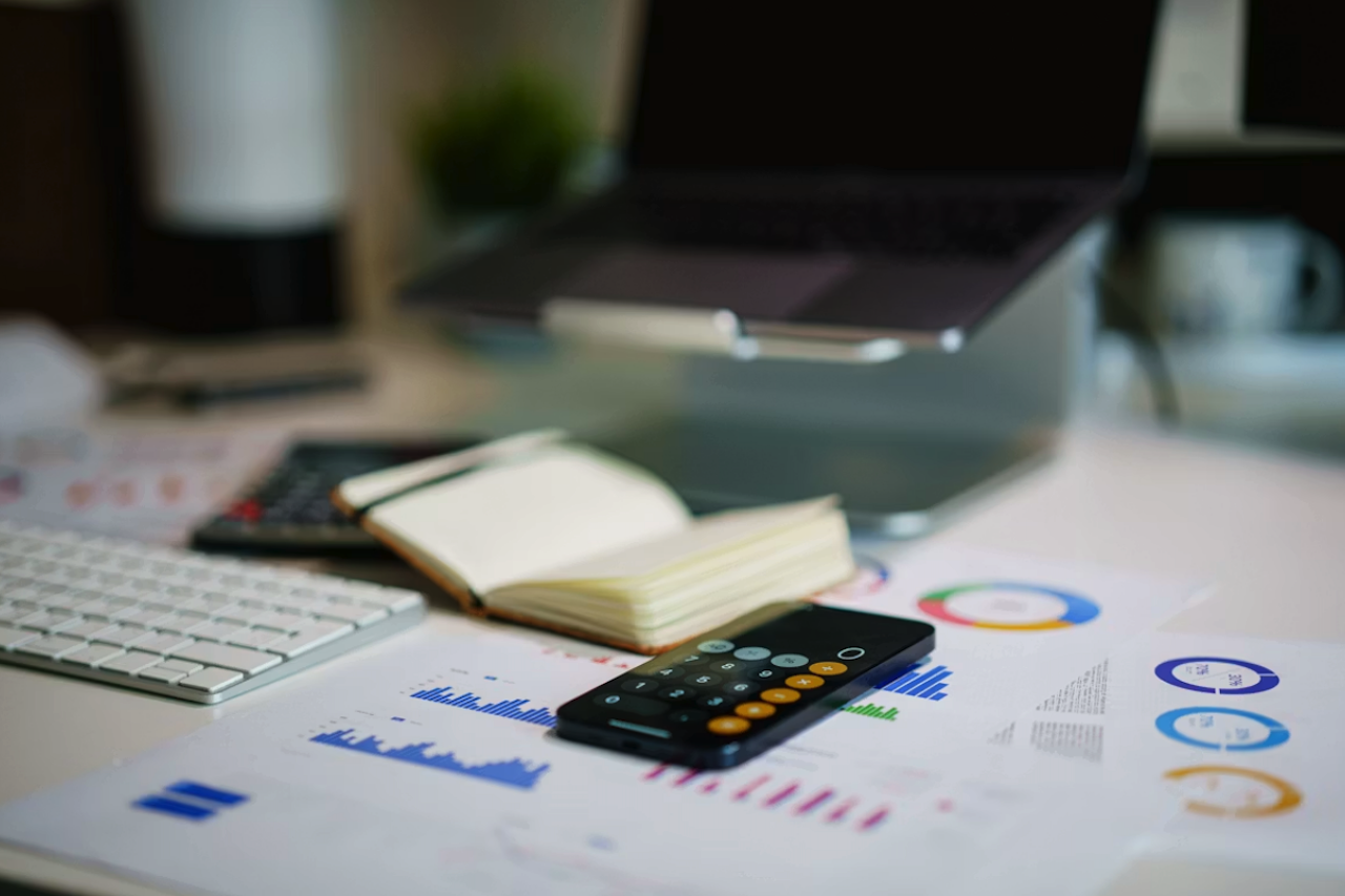 Office desk with smartphone and financial charts